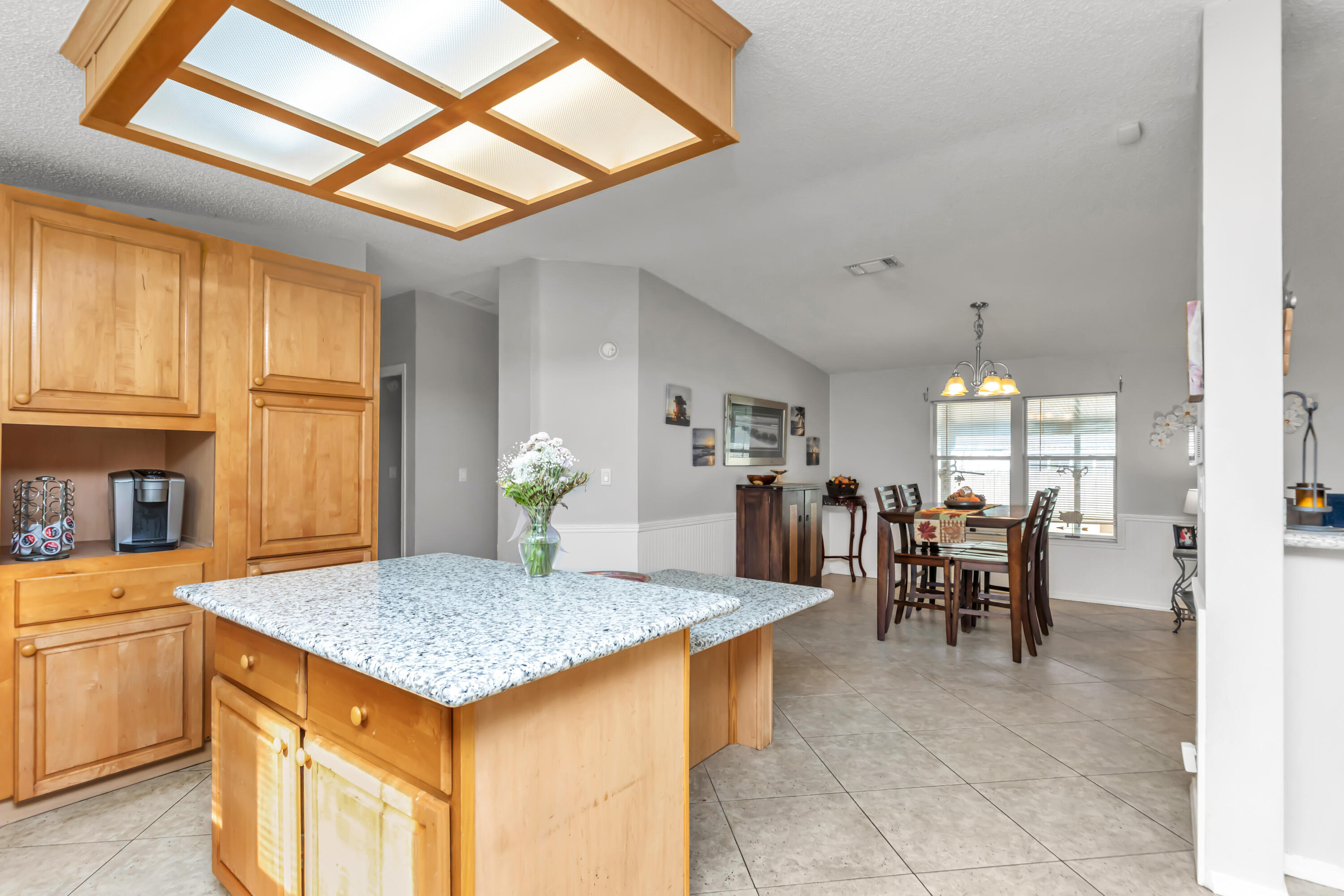 7478 Rose Street Navarre, FL 32566 - Photo 29 of 60 a living room with dining table and chairs