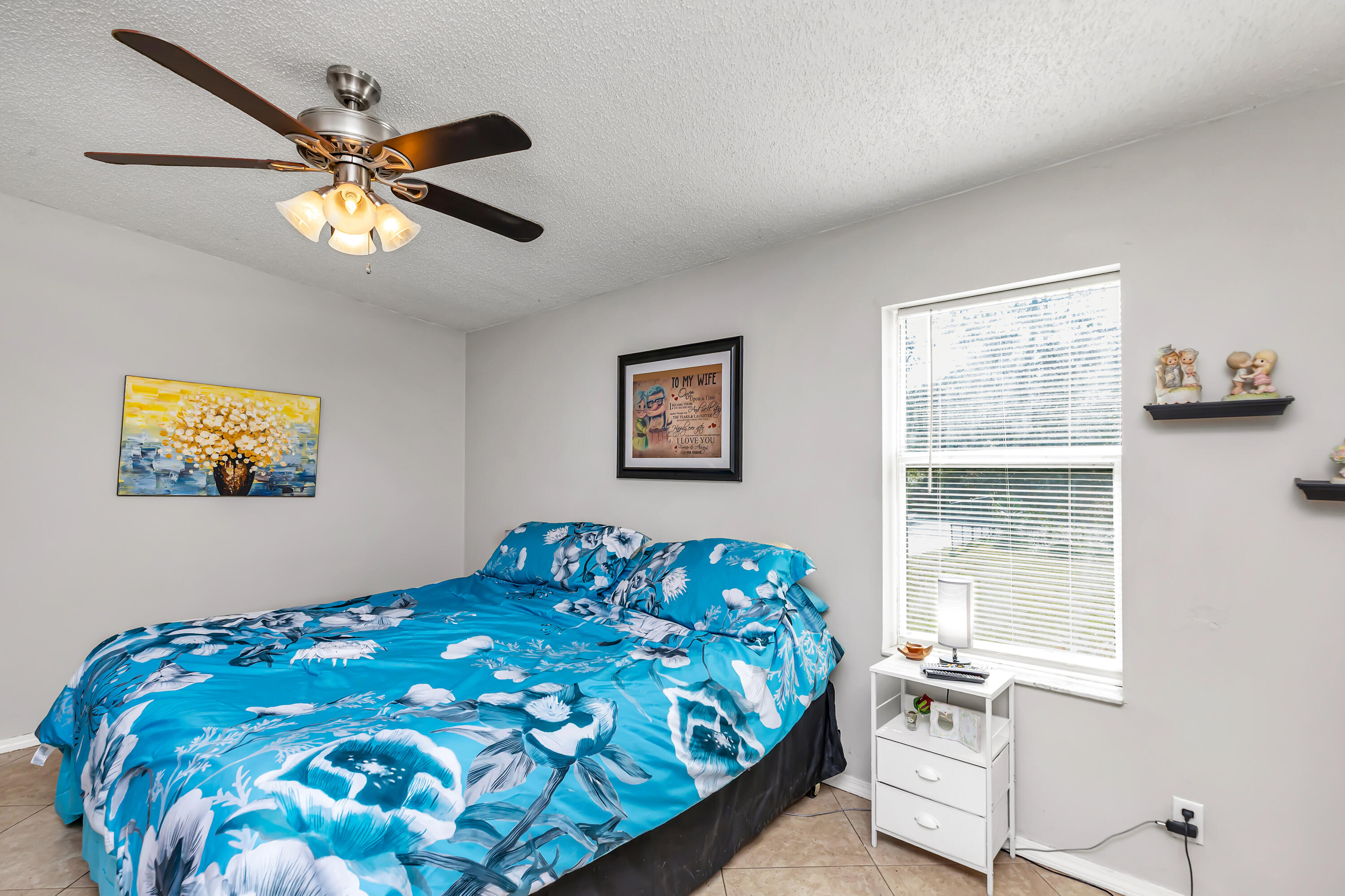 7478 Rose Street Navarre, FL 32566 - Photo 32 of 60 a bedroom with a bed and a window