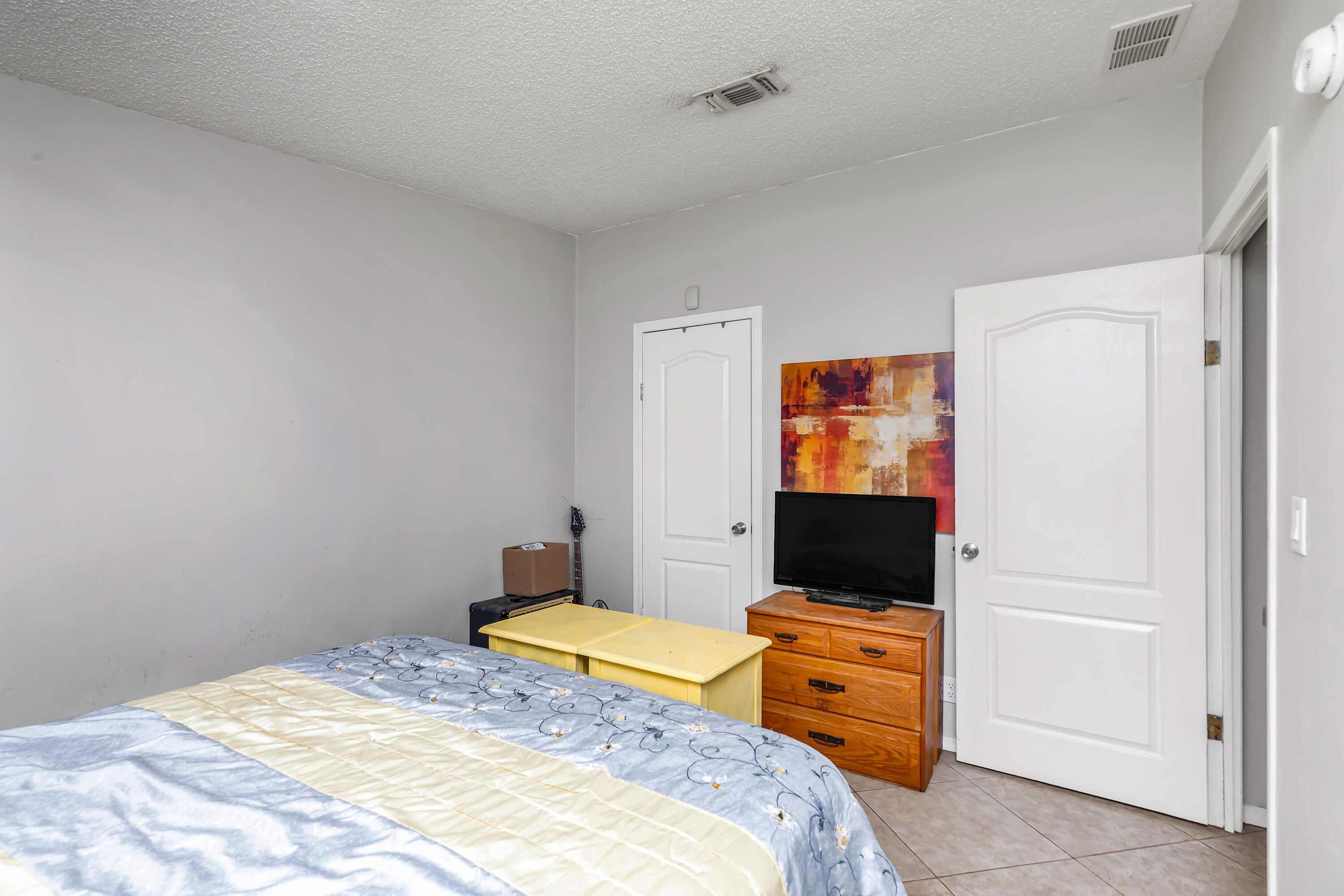 7478 Rose Street Navarre, FL 32566 - Photo 40 of 60 a bedroom with a bed and a flat screen tv