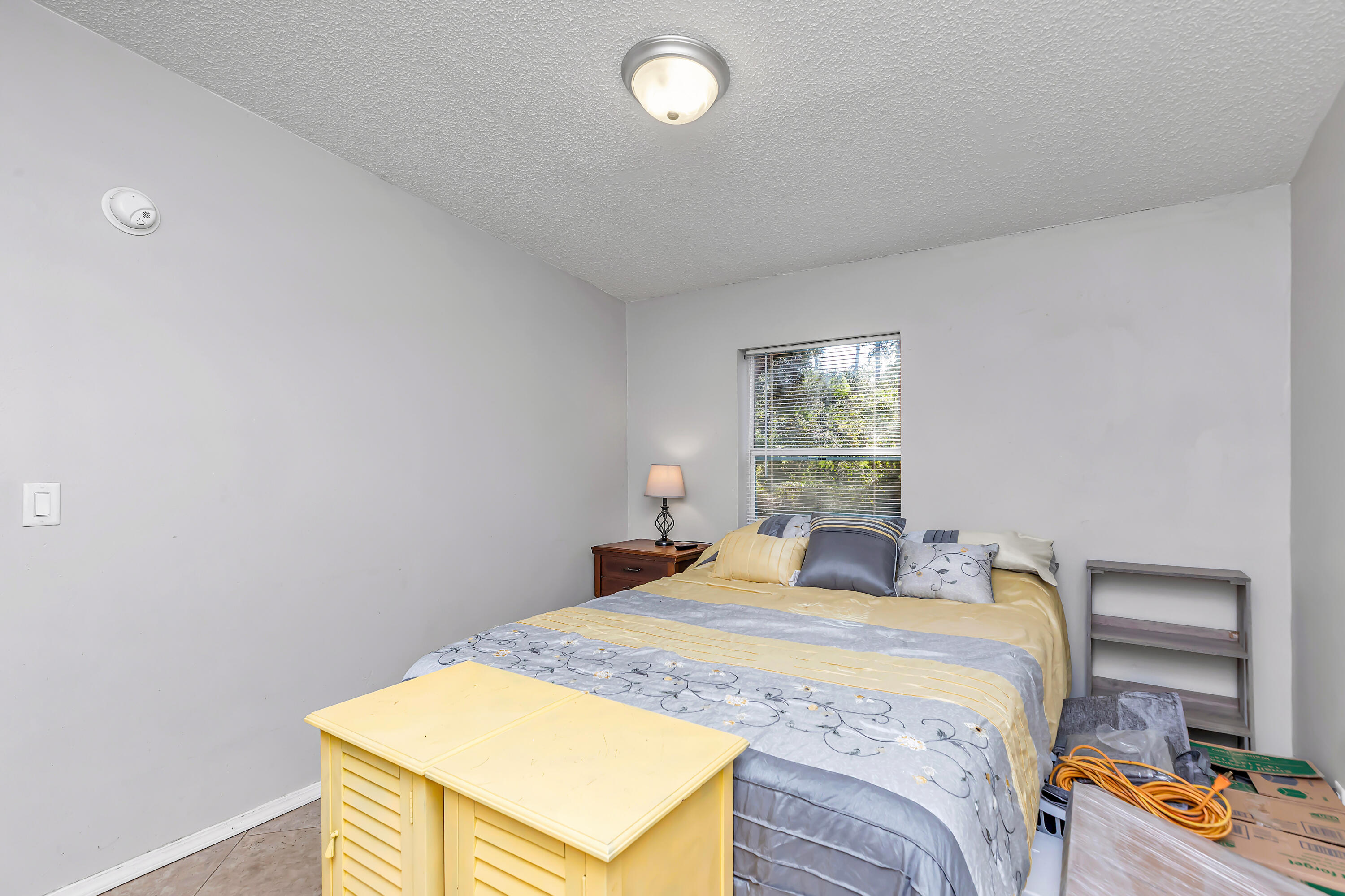 7478 Rose Street Navarre, FL 32566 - Photo 41 of 60 a bedroom with a bed and a window