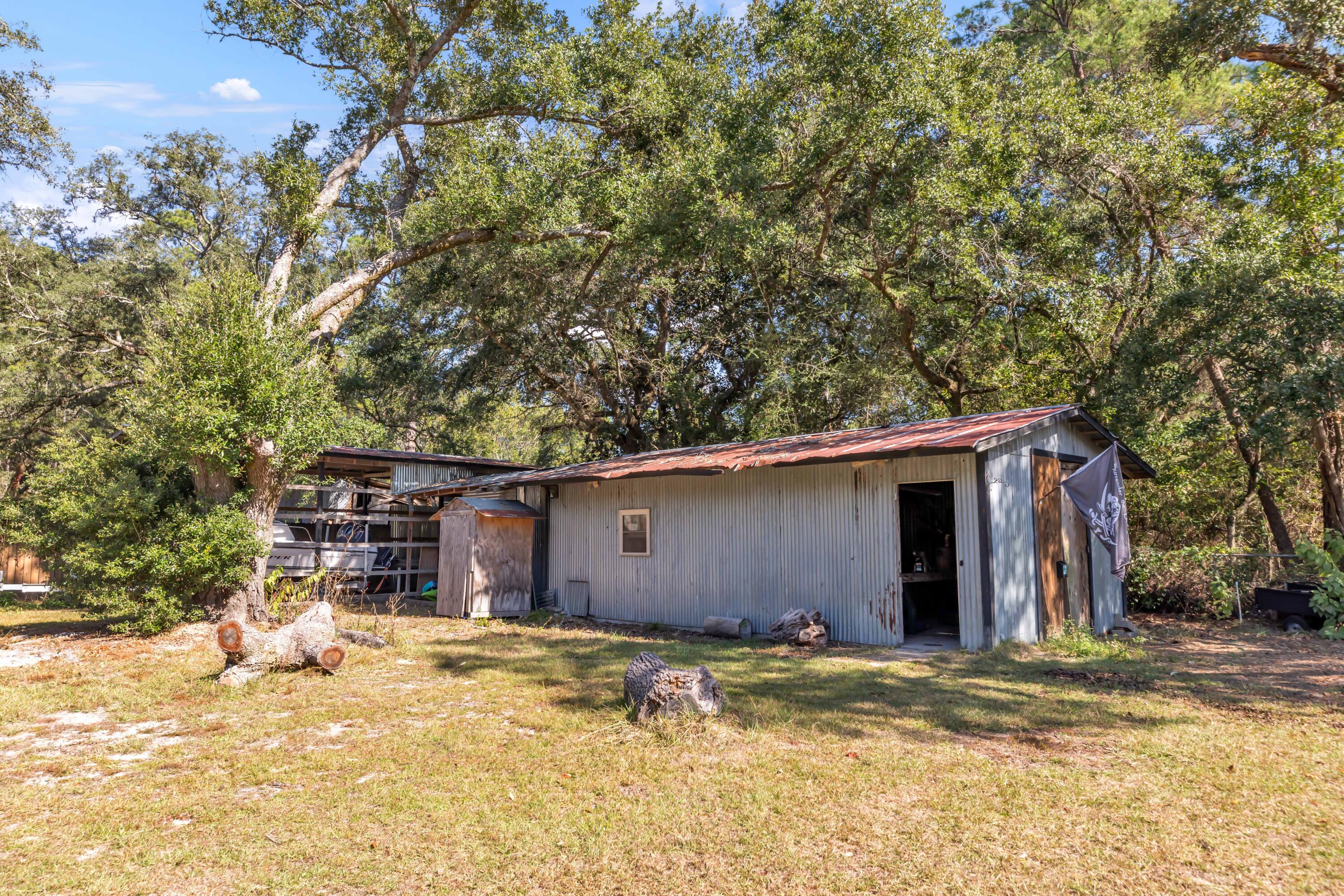 7478 Rose Street Navarre, FL 32566 - Photo 50 of 60 a view of a house with a yard
