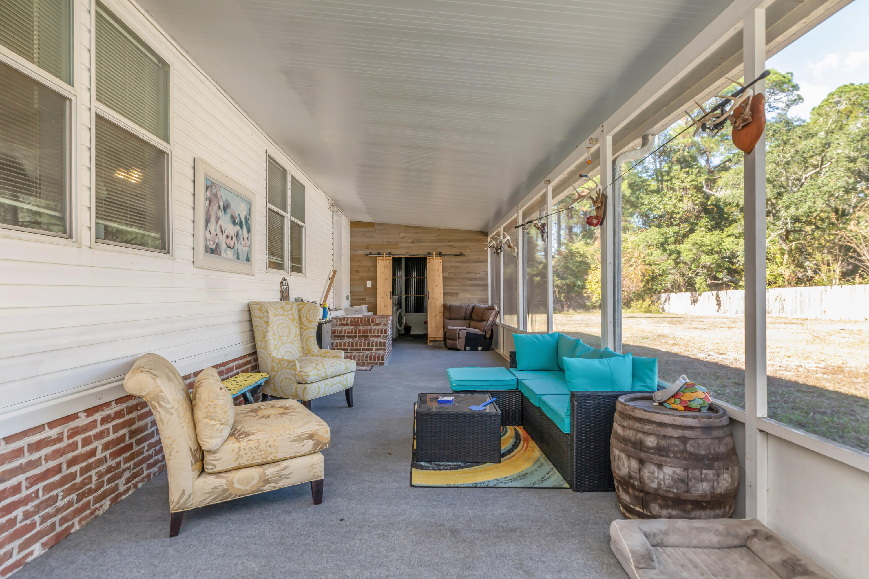 7478 Rose Street Navarre, FL 32566 - Photo 7 of 60 a living room with furniture and a floor to ceiling window