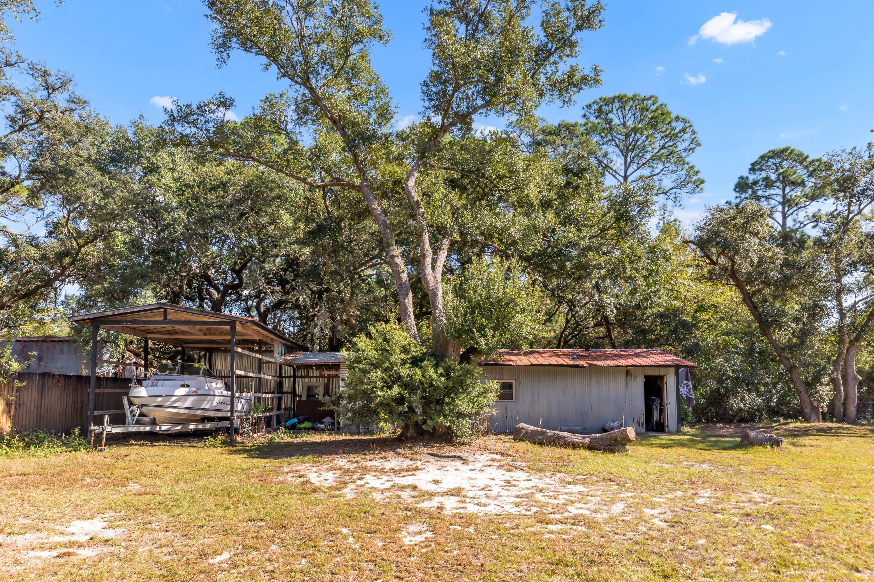 7478 Rose Street Navarre, FL 32566 - Photo 8 of 60 a view of a house with a patio