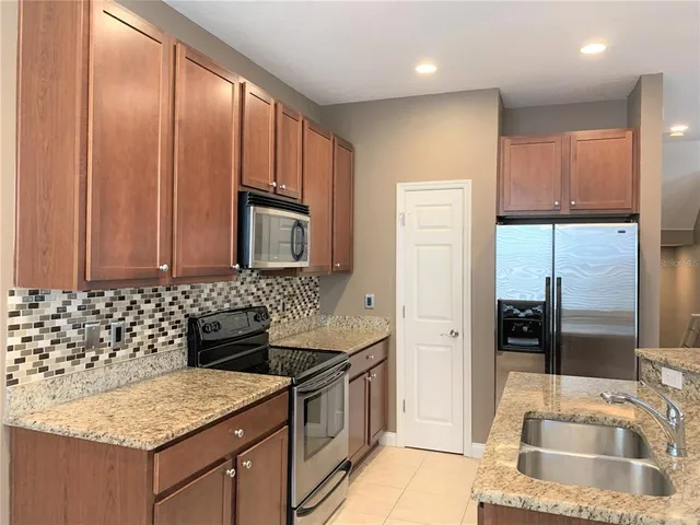 a kitchen with a sink stove and refrigerator