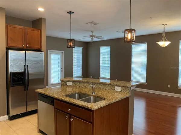 a kitchen with center island and stainless steel appliances