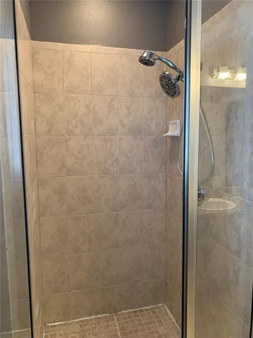 a bathroom with a glass shower door