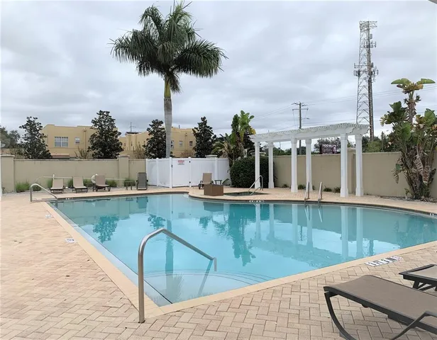 a view of a swimming pool with a lounge chair
