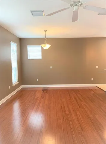 a view of a room with wooden floor and window