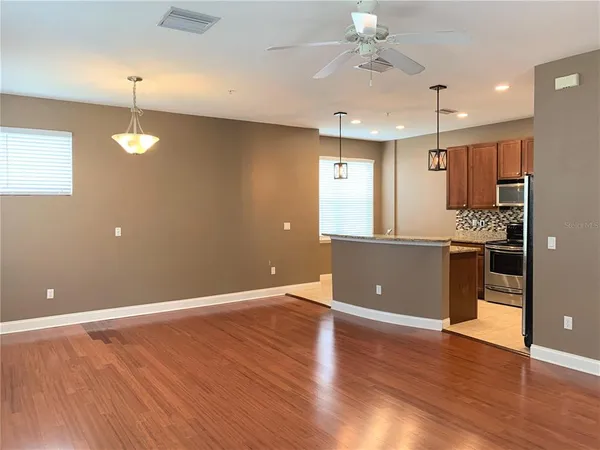 a view of a kitchen with a sink and a ceiling fan