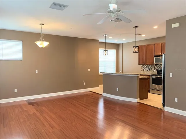 a view of a kitchen with a sink and a ceiling fan