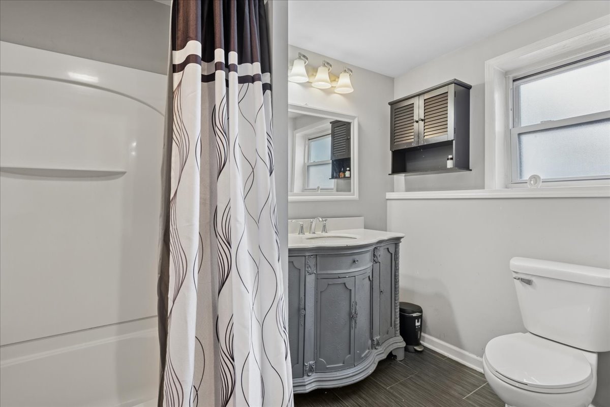 128 McCabe Drive Streamwood, IL 60107 - Photo 17 of 19 a bathroom with a sink a toilet and shower