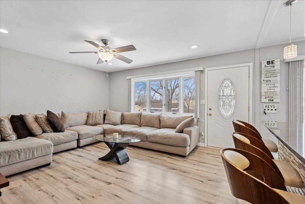 128 McCabe Drive Streamwood, IL 60107 - Photo 3 of 19 a living room with furniture a ceiling fan and a rug