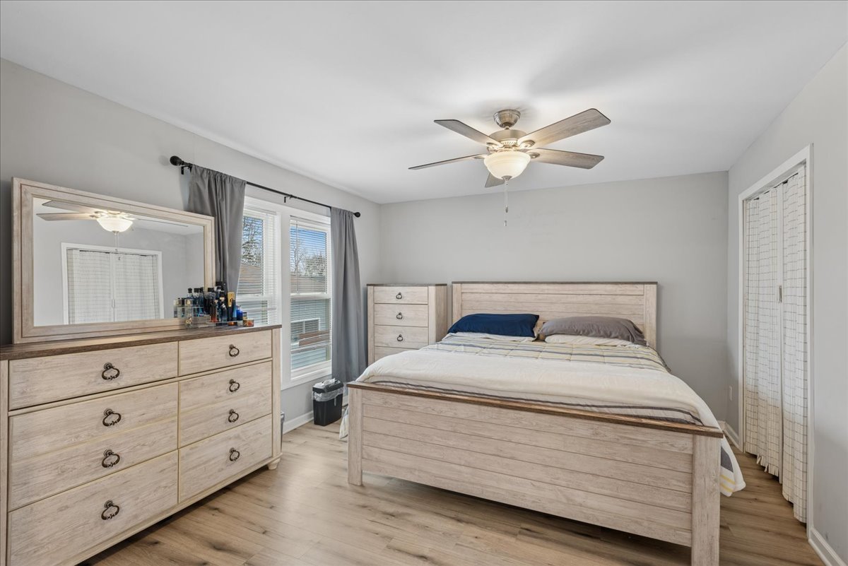 128 McCabe Drive Streamwood, IL 60107 - Photo 10 of 19 a bedroom with a bed and a chandelier