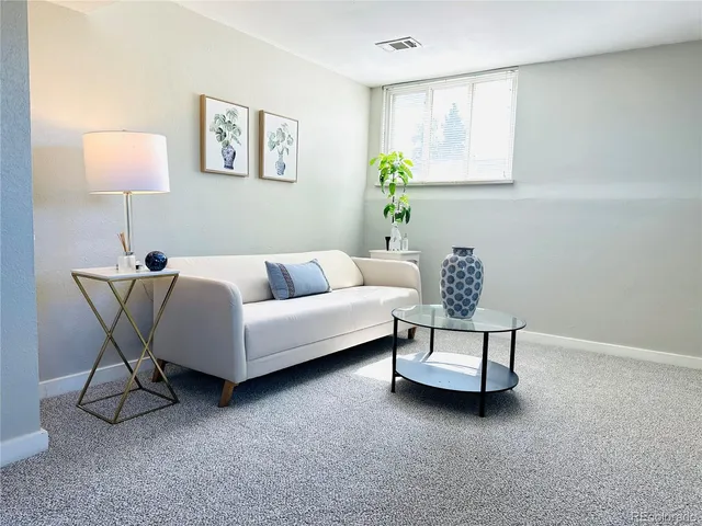 a living room with furniture and a lamp