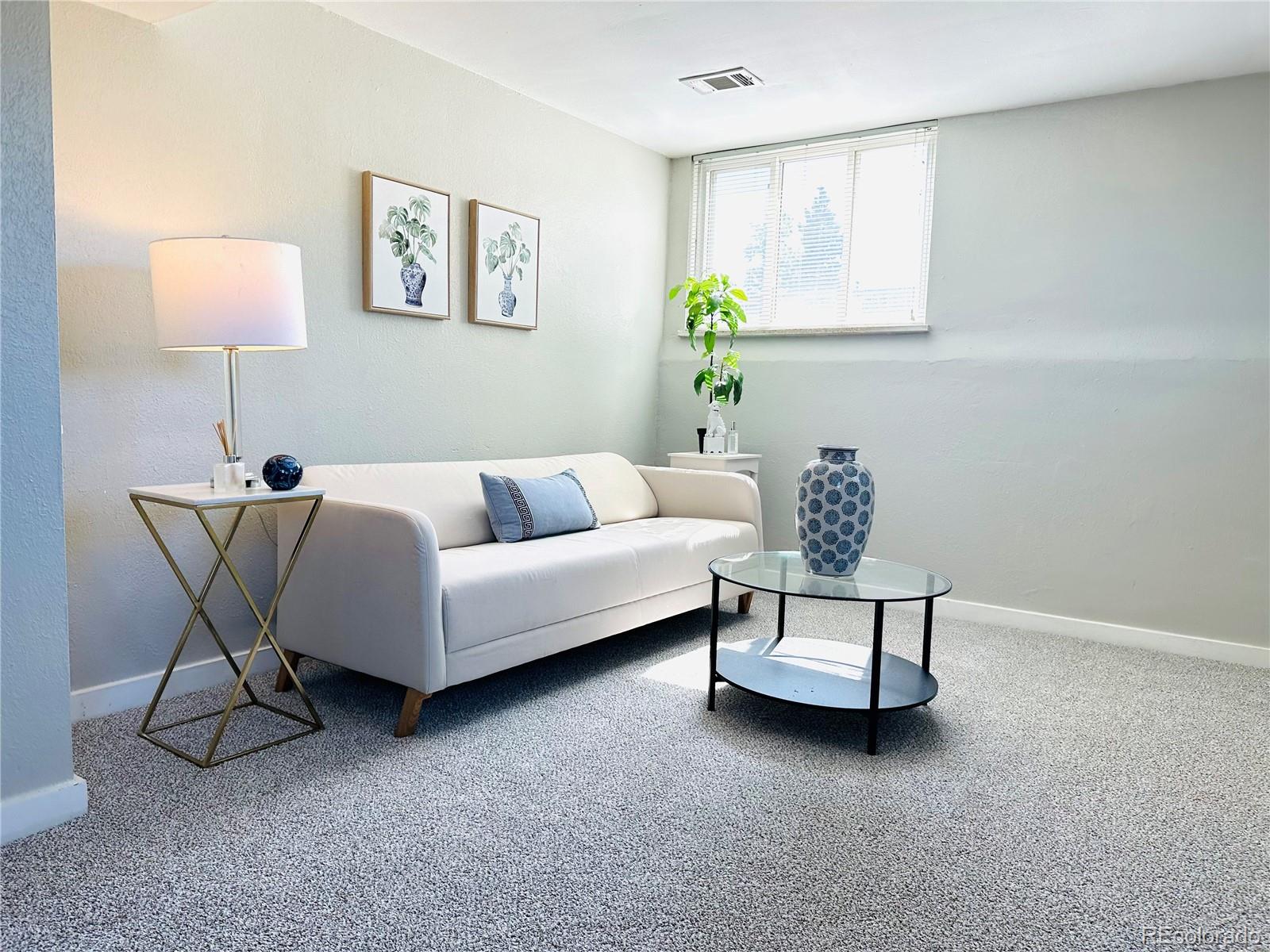 a living room with furniture and a lamp