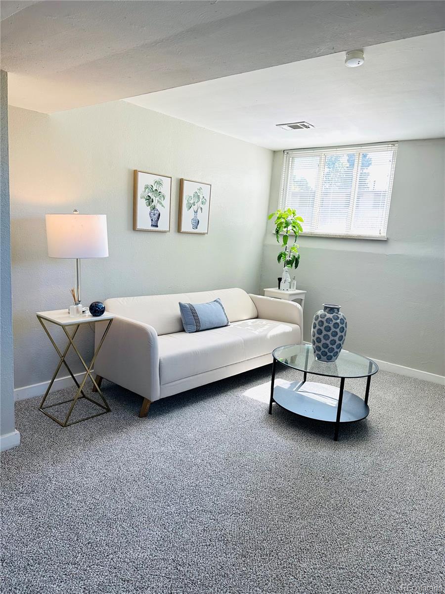 1400 South Clermont Street, Unit 7 Denver, CO 80222 - Photo 5 of 20 a living room with furniture and a potted plant