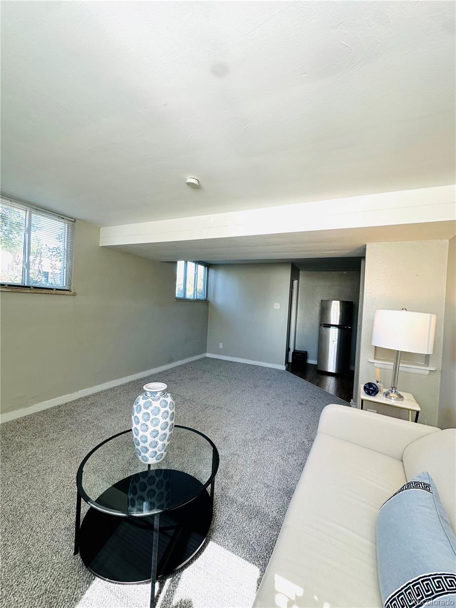 1400 South Clermont Street, Unit 7 Denver, CO 80222 - Photo 6 of 20 a living room with furniture and a chandelier