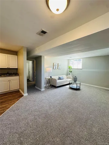 a spacious bedroom with a bed and cabinets
