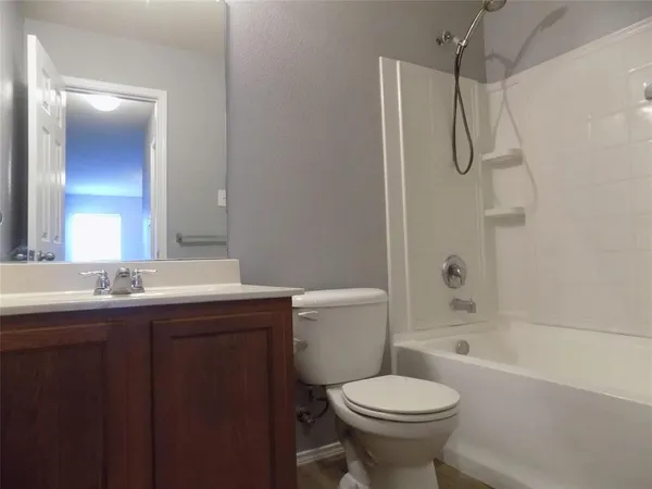 a bathroom with a granite countertop toilet sink and shower