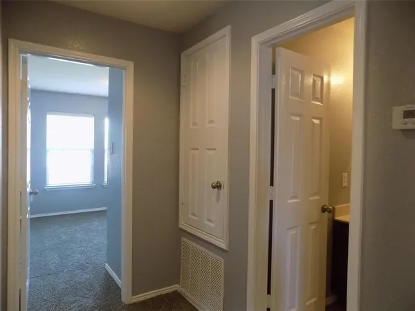 a view of a bathroom from a hallway