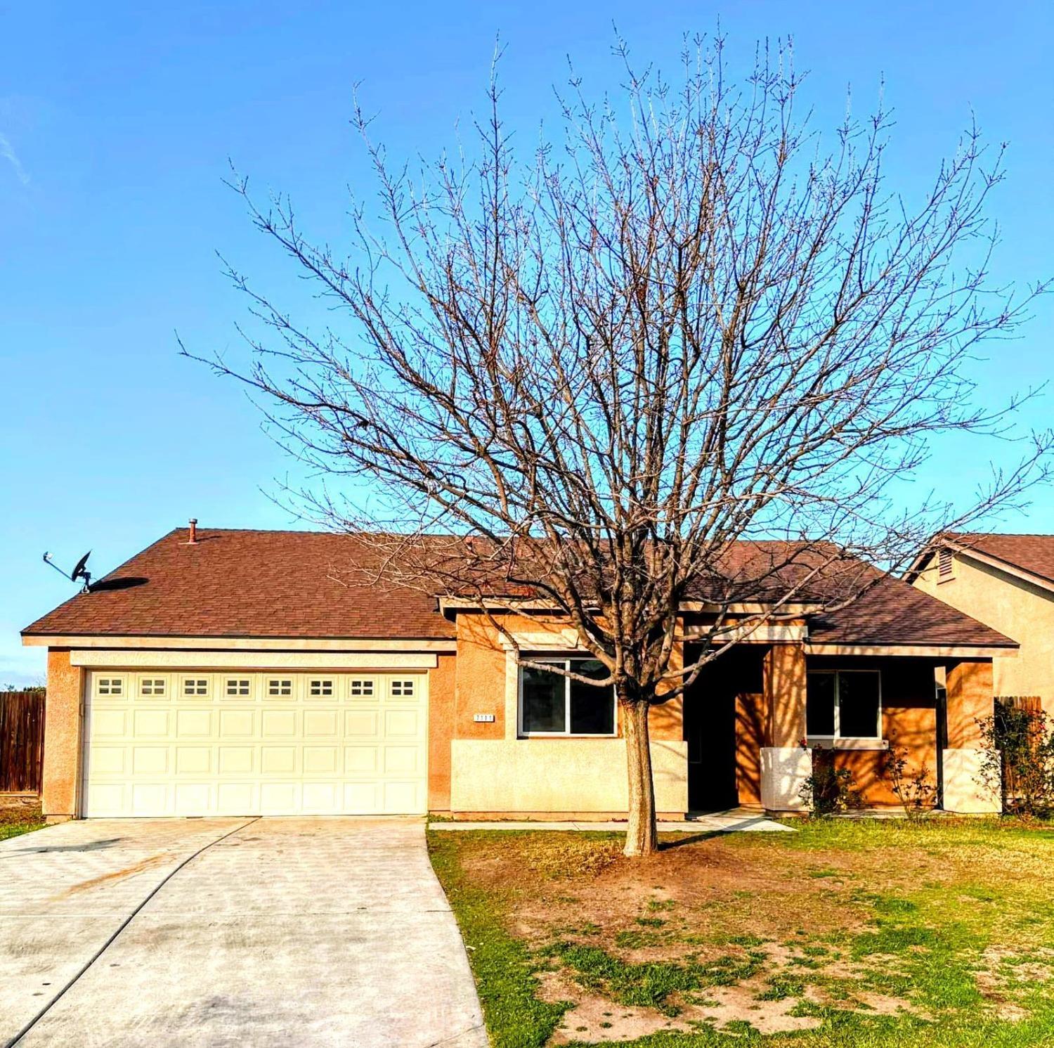 7111 Santana Sun Drive Bakersfield, CA 93313 - Photo 1 of 13 a front view of a house with a yard