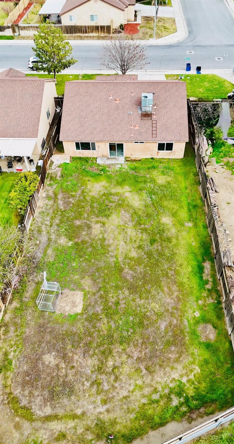 7111 Santana Sun Drive Bakersfield, CA 93313 - Photo 12 of 13 a aerial view of a house with a yard basket ball court and outdoor seating