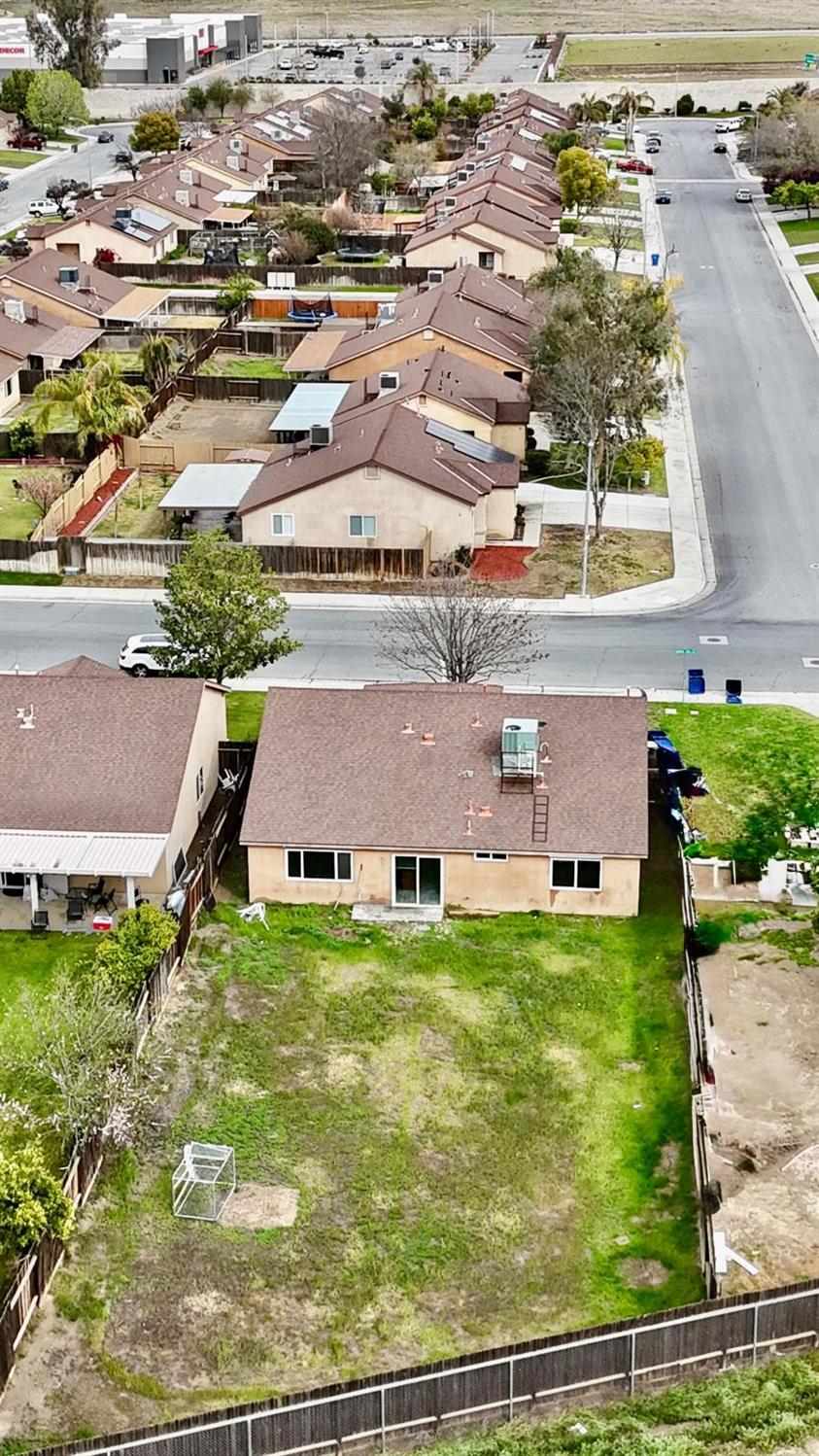 7111 Santana Sun Drive Bakersfield, CA 93313 - Photo 13 of 13 an aerial view of residential houses with outdoor space and parking
