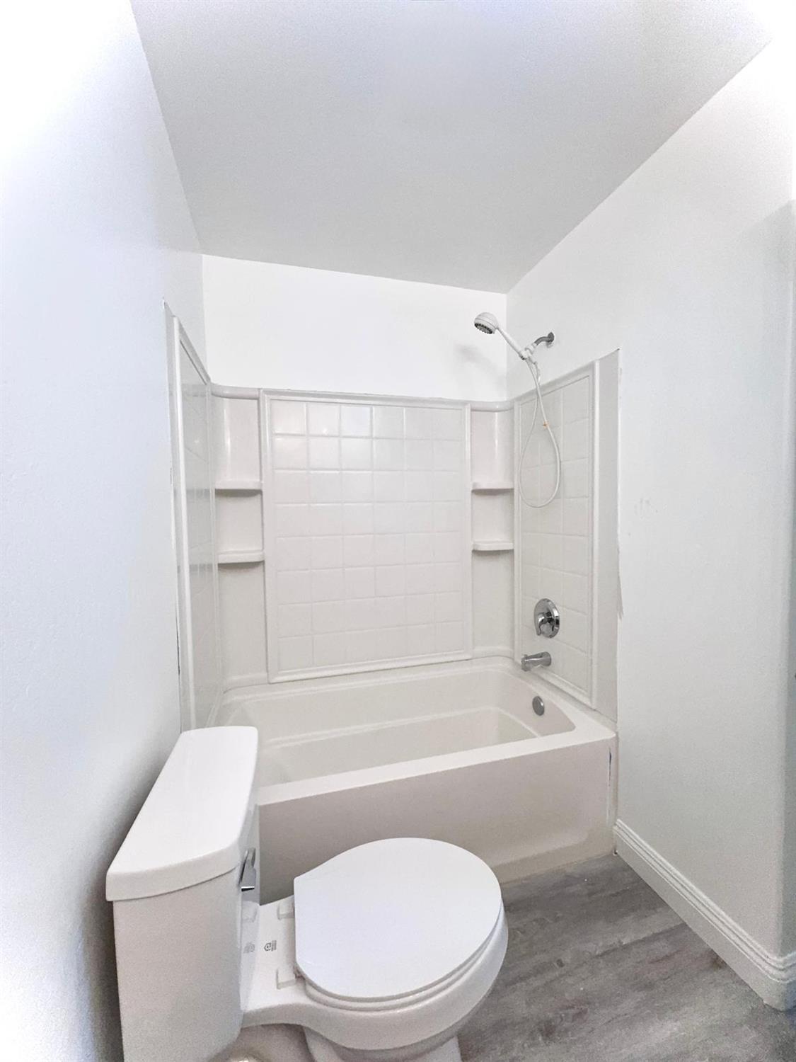 7111 Santana Sun Drive Bakersfield, CA 93313 - Photo 5 of 13 a bathroom with a toilet and a bathtub