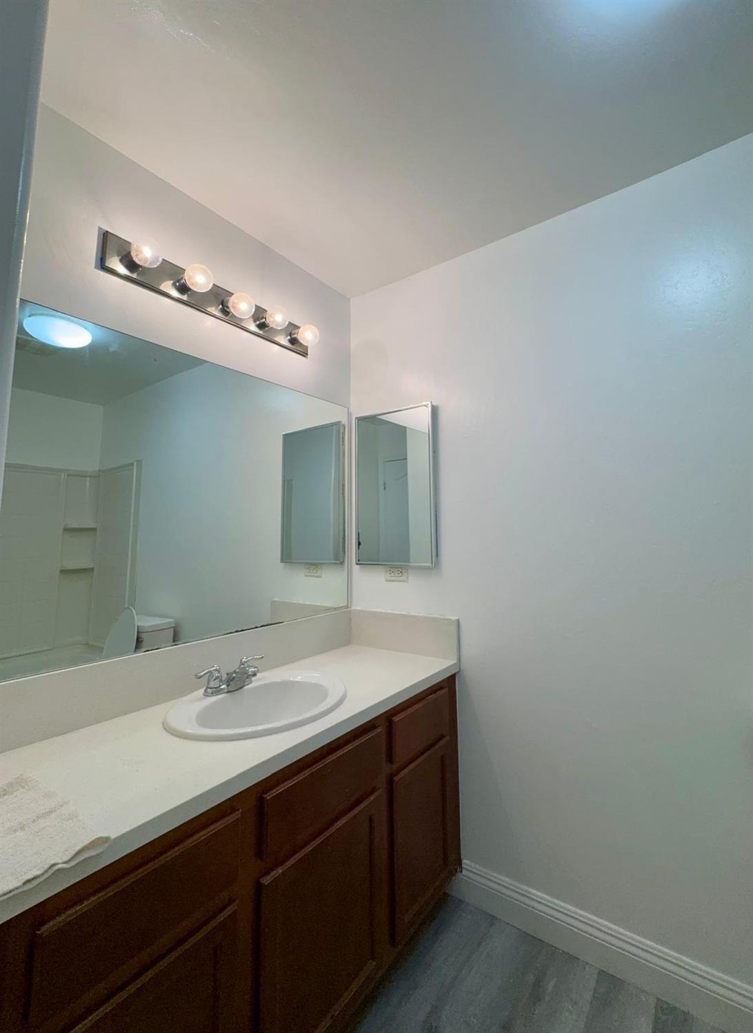 7111 Santana Sun Drive Bakersfield, CA 93313 - Photo 9 of 13 a bathroom with a sink and a mirror