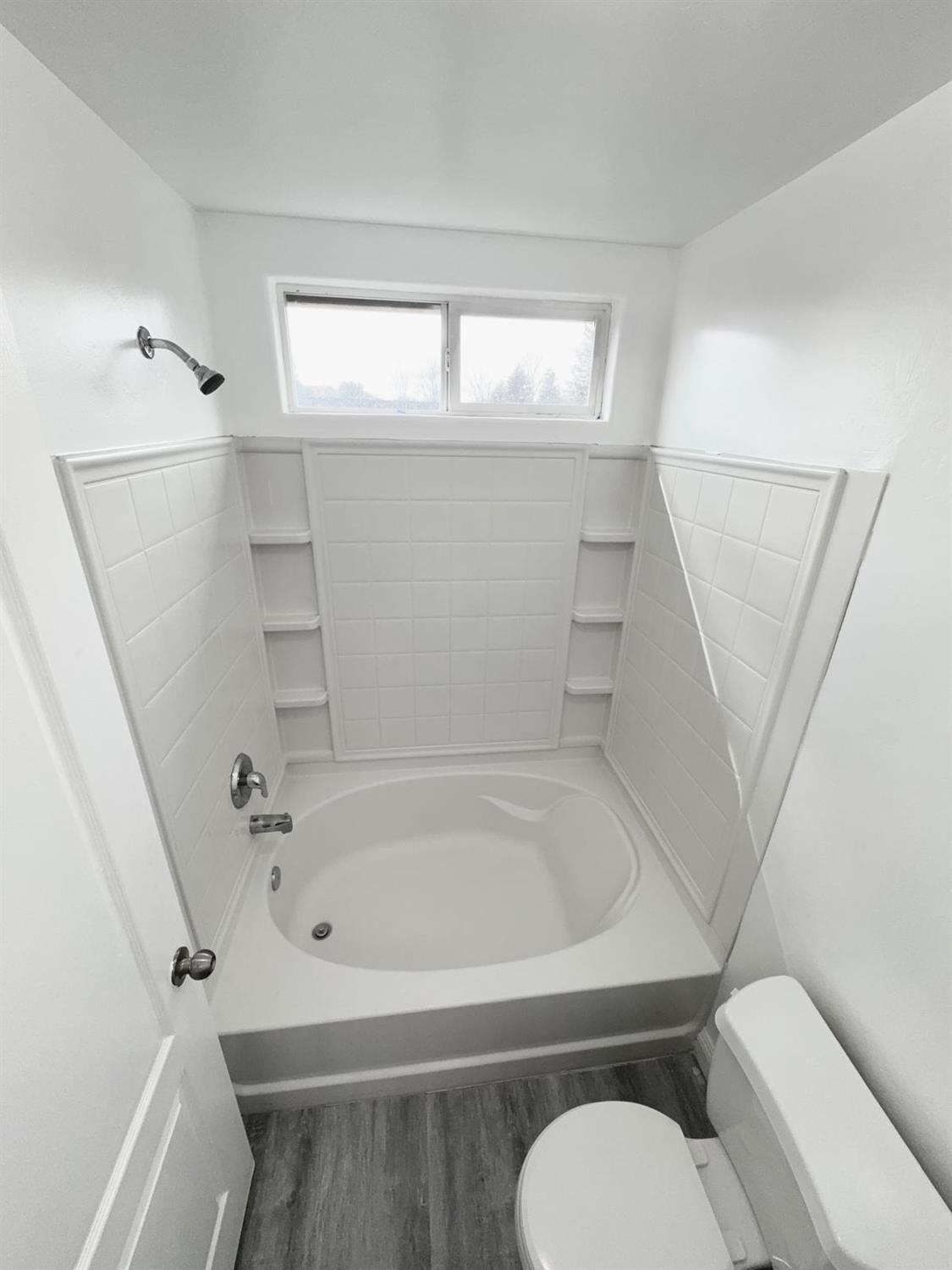 7111 Santana Sun Drive Bakersfield, CA 93313 - Photo 10 of 13 a bathroom with a toilet and a bathtub