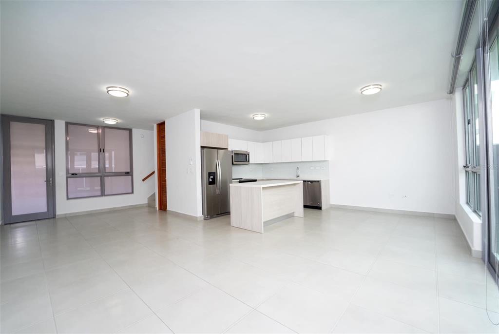 71 Ace Bayamon, PR 00959 - Photo 5 of 19 a view of a kitchen with refrigerator and white cabinets