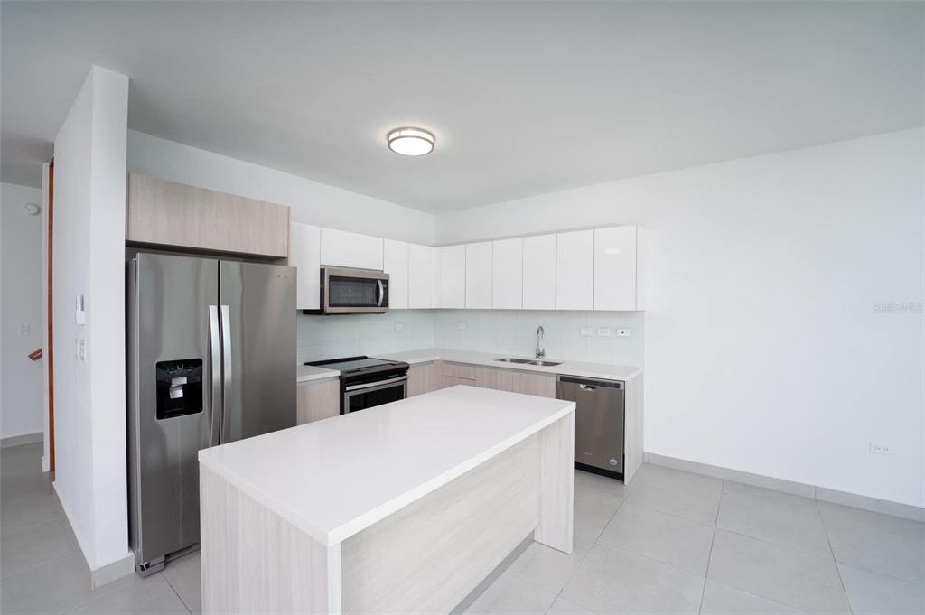 71 Ace Bayamon, PR 00959 - Photo 10 of 19 a kitchen with stainless steel appliances a refrigerator sink and microwave