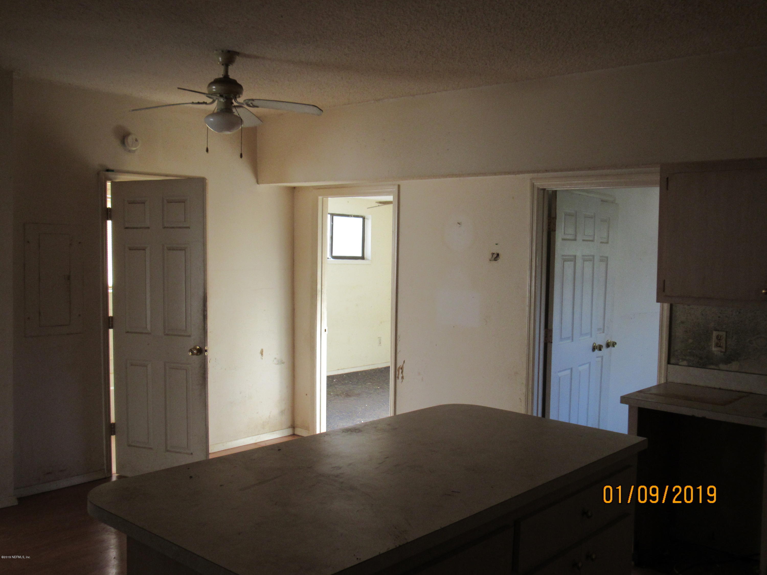 1578 Baxley Road Middleburg, FL 32068 - Photo 8 of 9 a view of a livingroom with a furniture wooden floor and a ceiling fan