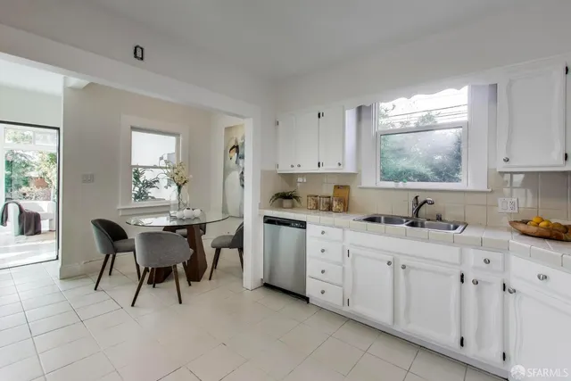 a kitchen with cabinets and chairs in it