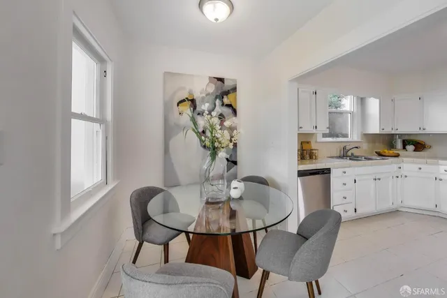 a kitchen with a table and chairs in it