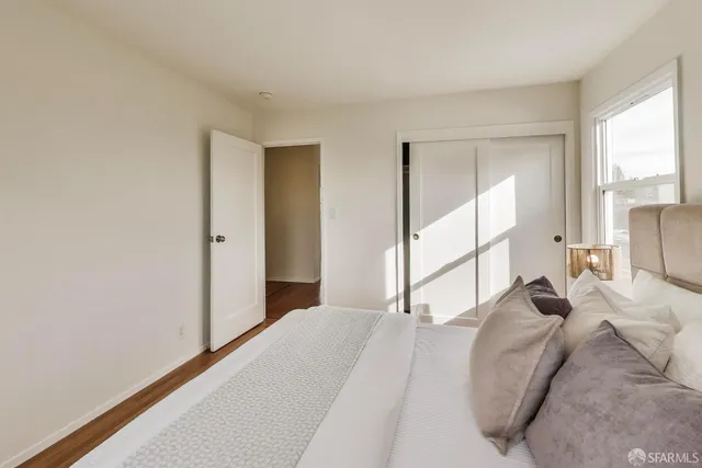 a bedroom with a large bed and a large window