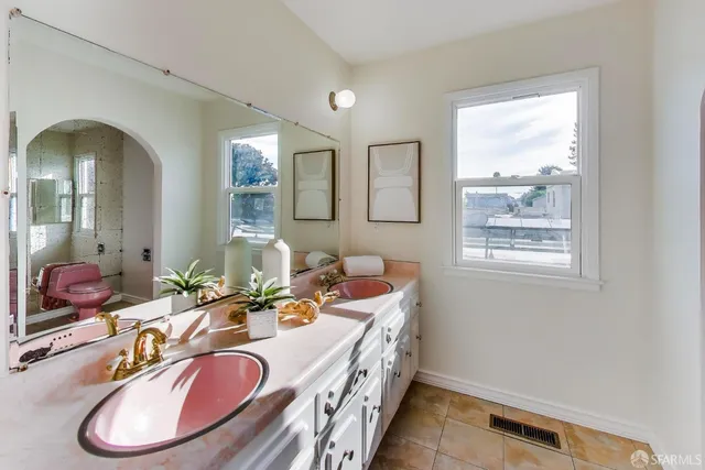 a bathroom with a double vanity sink and a mirror