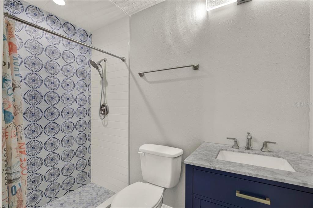7487 River Country Drive Weeki Wachee, FL 34607 - Photo 38 of 53 a bathroom with a granite countertop sink toilet and a mirror
