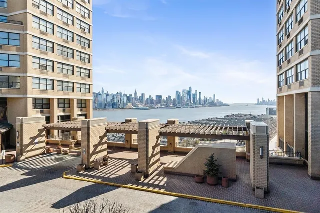 a view of roof deck with seating space and city view
