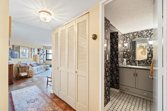 a spacious bathroom with a shower a sink and a mirror