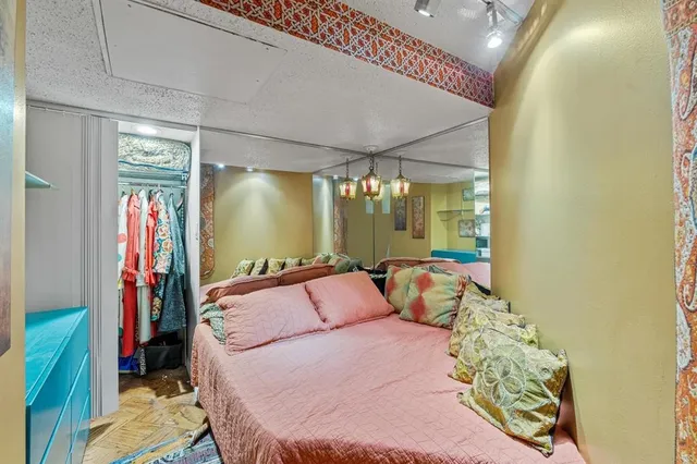 a bedroom with a bed and a mirror