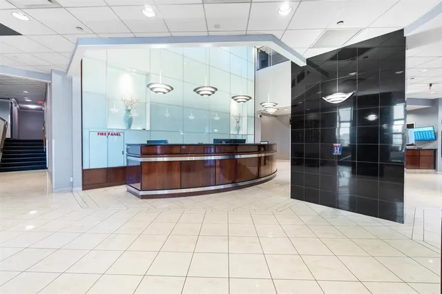 a view of a bathroom with a bathtub and a chandelier fan