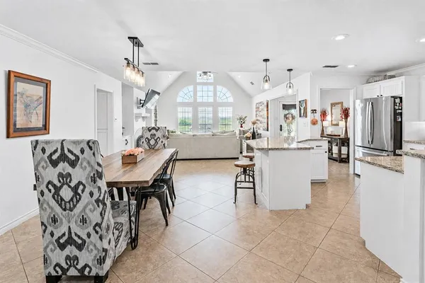 a living room with furniture a fireplace and a chandelier