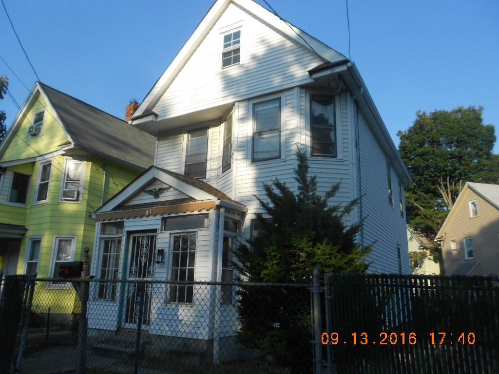 412 Dewey Street Bridgeport, CT 06605 - Photo 1 of 1 a front view of a house with a yard