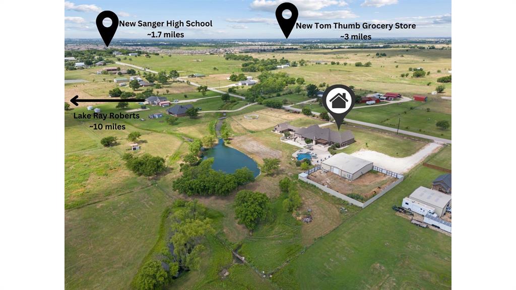 12190 Marion Road Sanger, TX 76266 - Photo 40 of 40 Expansive property showcasing a sizable main residence, a large outbuilding, and a private pond
