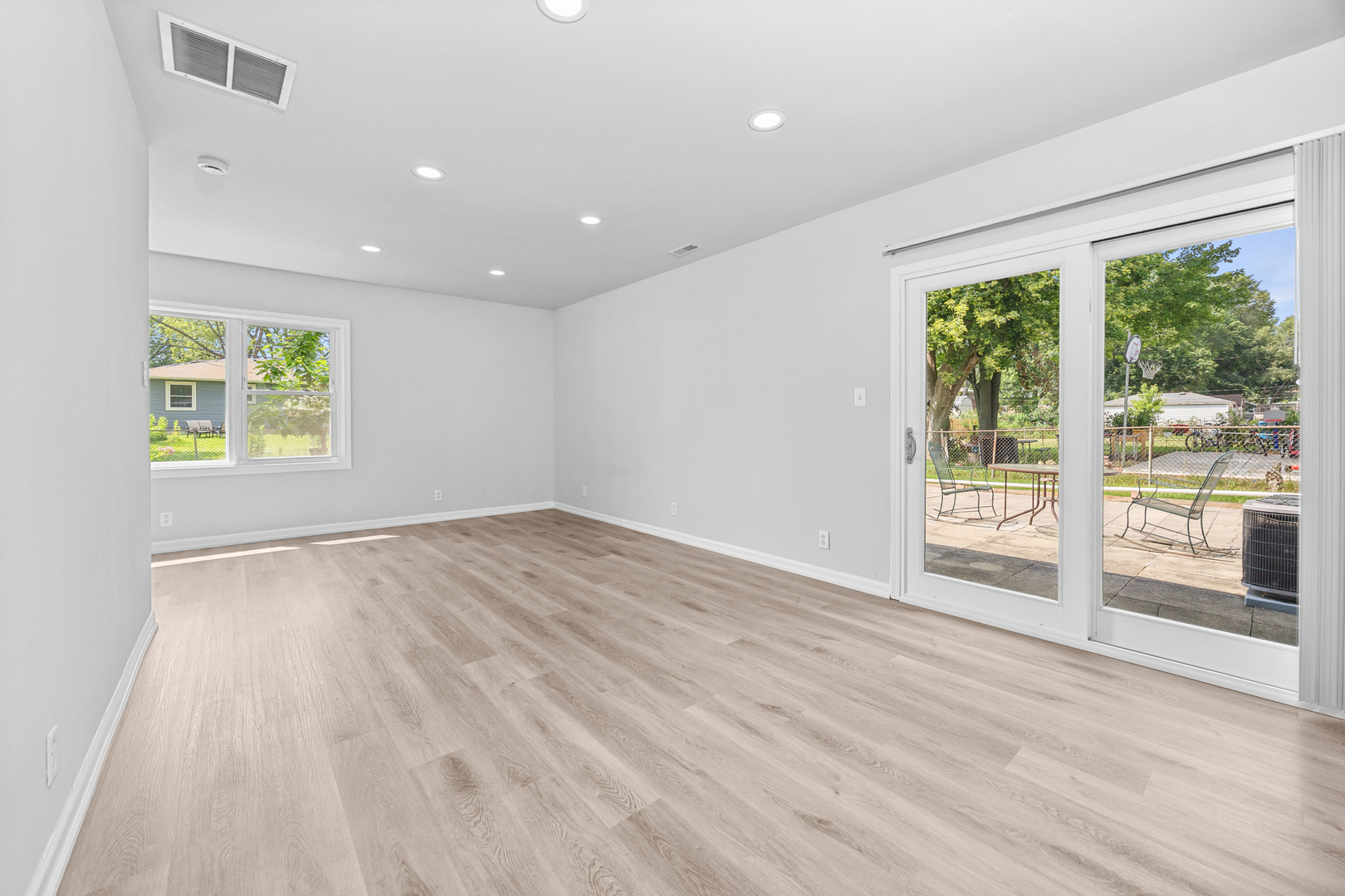 6640 Peach Tree Street Hanover Park, IL 60133 - Photo 18 of 27 an empty room with wooden floor and windows