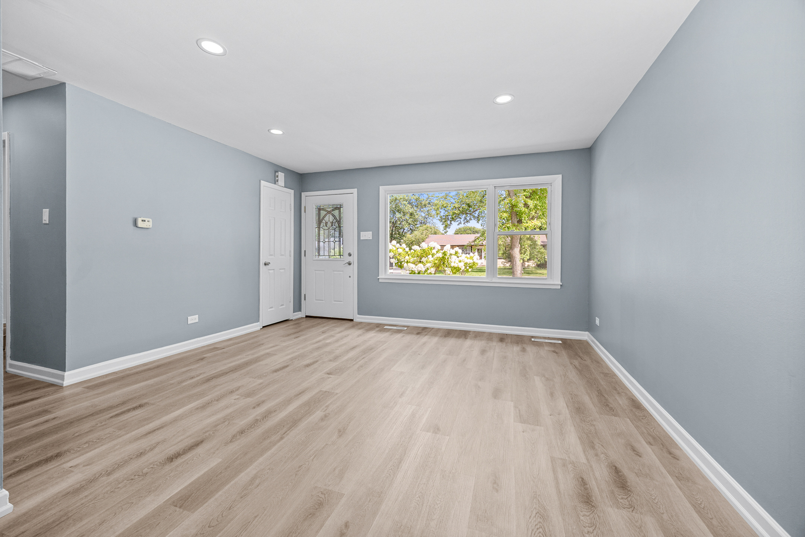 6640 Peach Tree Street Hanover Park, IL 60133 - Photo 5 of 27 wooden floor in an empty room with a window