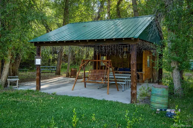 a view of a chair and table in the garden