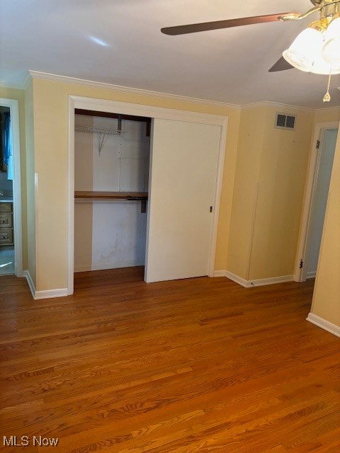 3620 Rambo Avenue Alliance, OH 44601 - Photo 9 of 14 Unfurnished bedroom with hardwood / wood-style flooring, a closet, ornamental molding, and ceiling fan