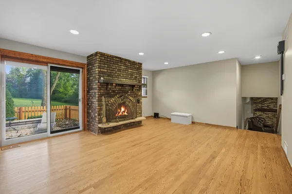 a view of an empty room with a fireplace and a large window